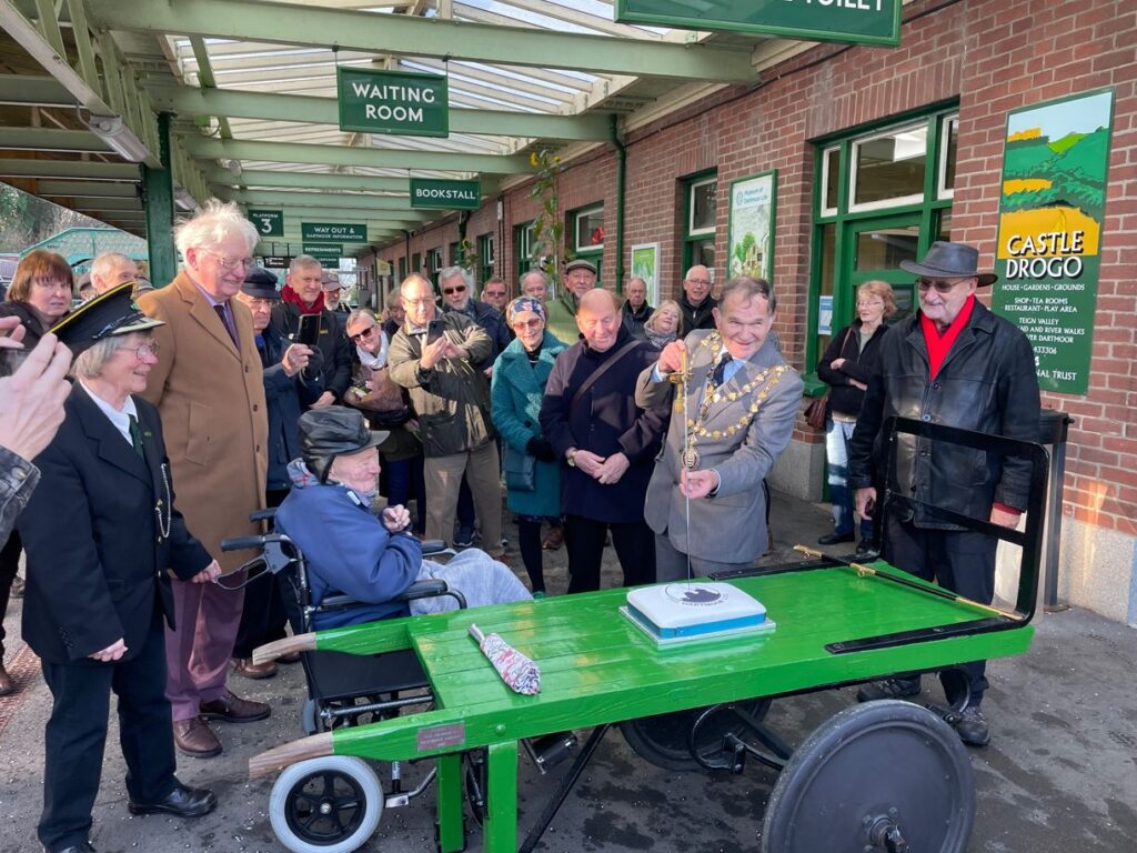 Okehampton Mayor Cllr Allenton Fisher cuts the birthday cake with his ceremonial naval sword